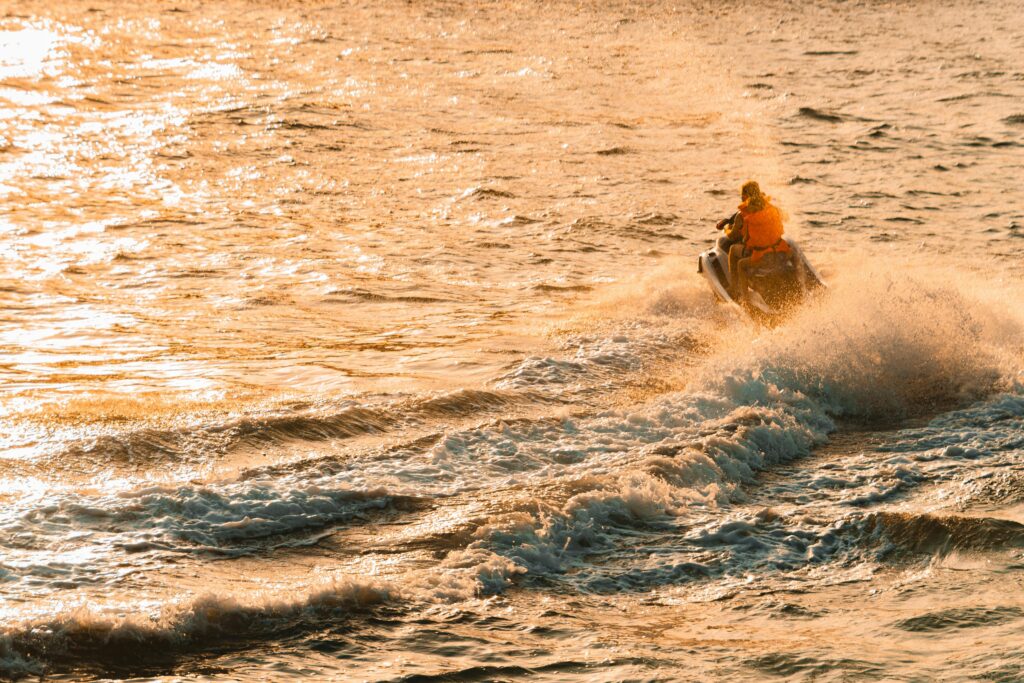 Experience thrilling jet skiing on Dubai waters during a stunning golden sunset.